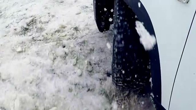 汽车车轮在雪地里打滑。4K。