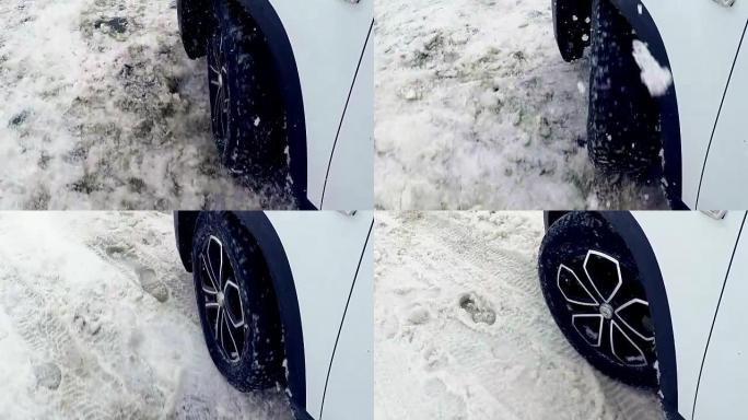 汽车车轮在雪地里打滑。4K。