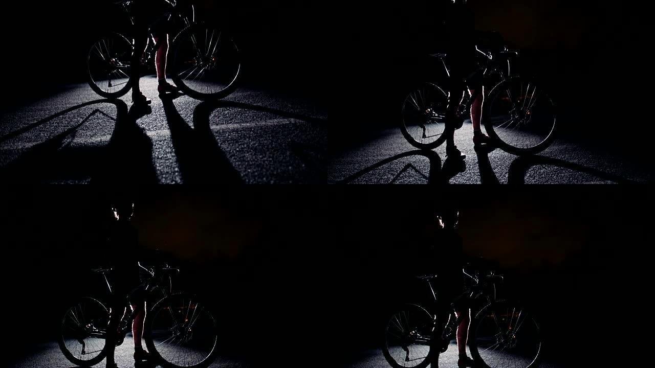 骑自行车的人摆姿势的低角度慢动作剪影