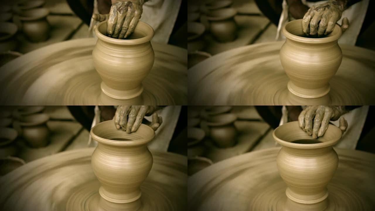 印度陶工在手动陶轮上熟练地手工成型壶