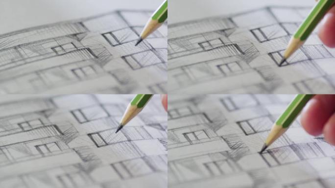 建筑师正在纸上画一座建筑