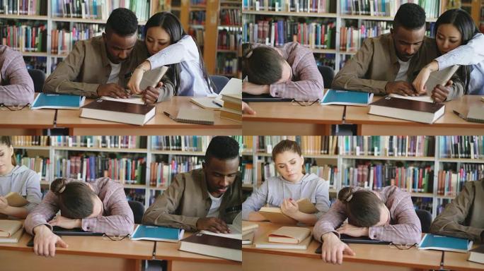 在大学图书馆里，勤奋的学生准备考试做作业和疲倦的家伙睡在桌子上