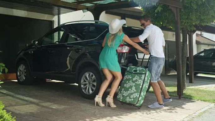 慢动作: 丈夫将行李箱装进汽车将妻子送回家中