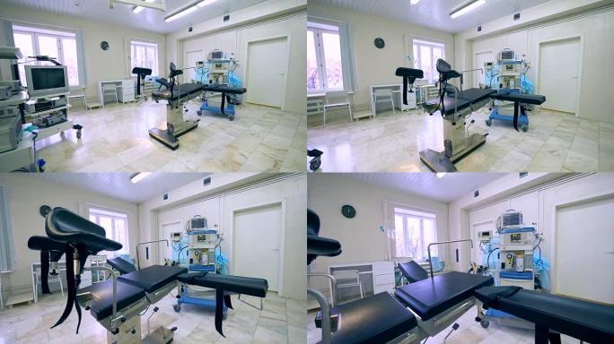 带有专业设备和检查椅的产科病房的侧视图