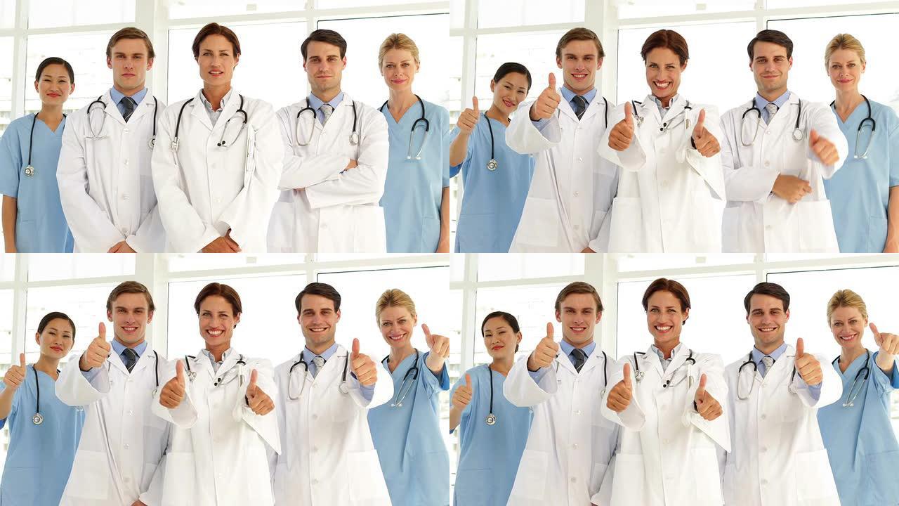 自信的医疗团队看着相机并竖起大拇指