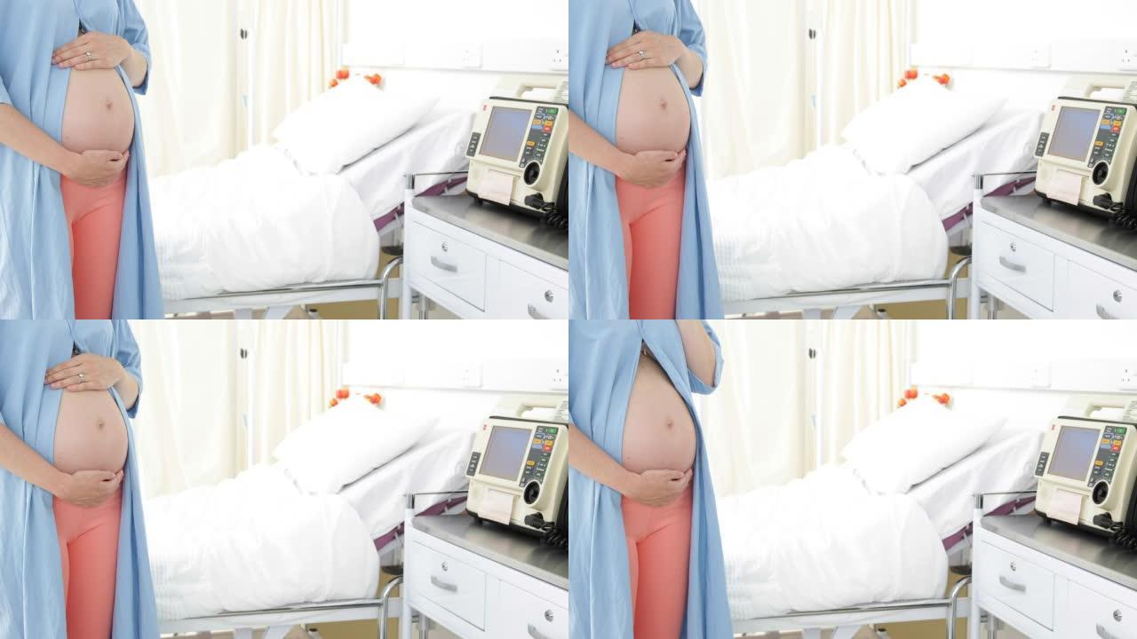 孕妇站在医院的长袍