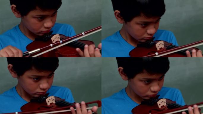 可爱的小学生在教室里拉小提琴