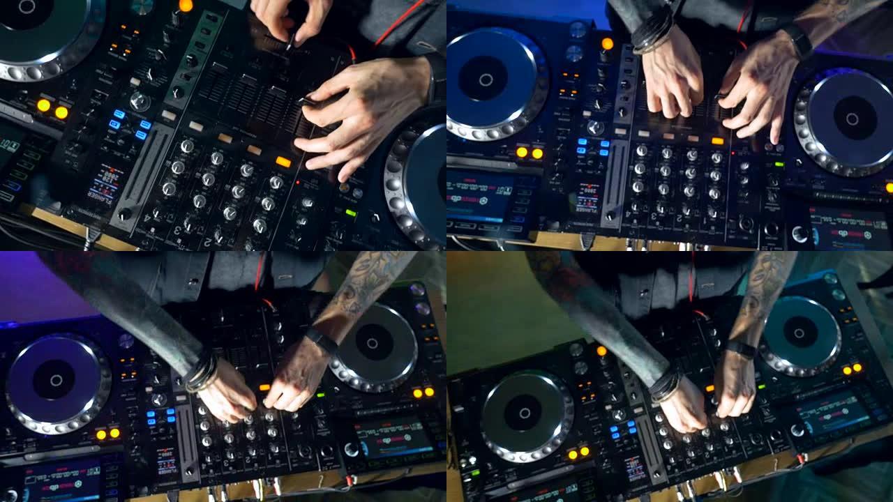 在夜总会使用调音台和转盘的dj手的特写镜头。