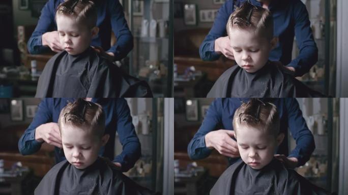 理发师修剪小男孩的头发