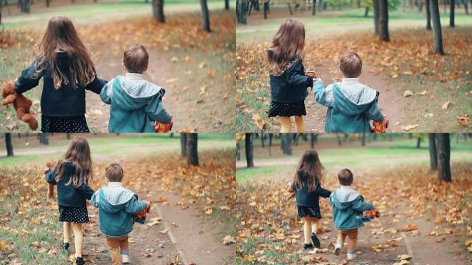 后视图可爱的兄妹小男孩和女孩牵着玩具在秋天的小巷慢动作中奔跑