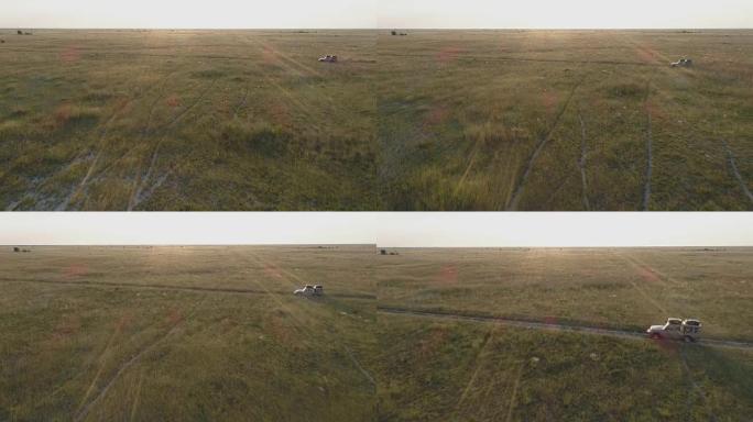 从空中俯瞰狩猎汽车在博茨瓦纳草原上行驶的景象