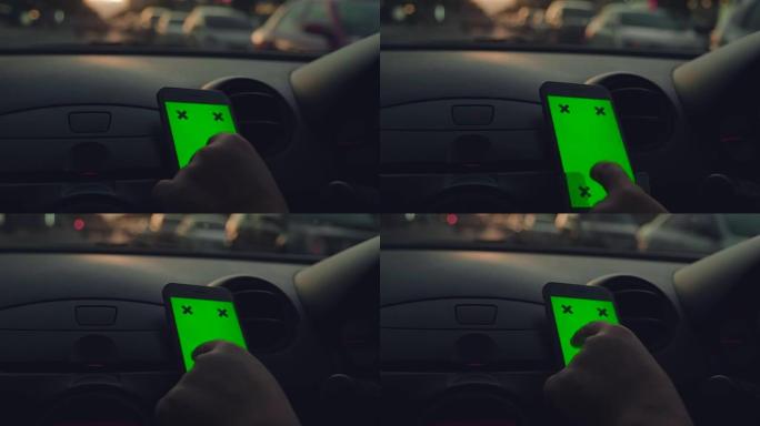 亚洲女性在汽车上使用智能手机的特写镜头，绿屏