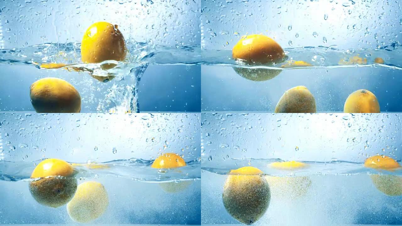 三个新鲜柠檬以高对比度拍摄掉入水中。