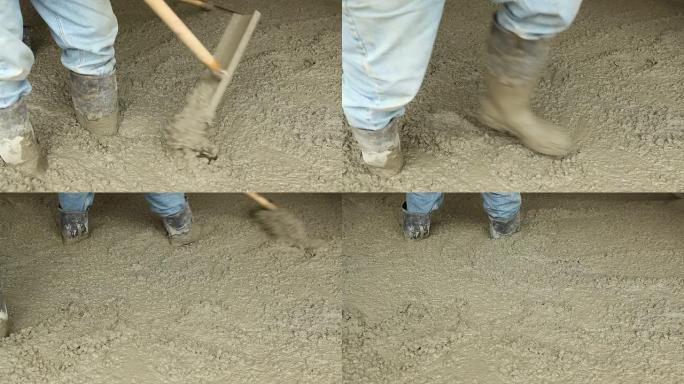 工人使用摊铺机工具分配混凝土