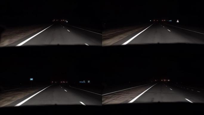 夜间驾驶汽车在乡间小路上行驶。汽车在运动。从车内观看