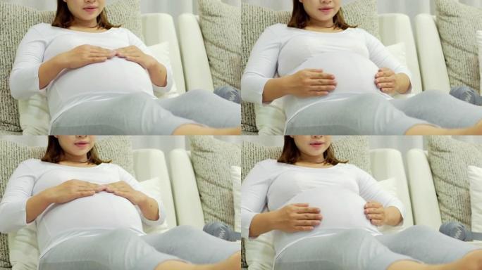 Pregnant woman asian relaxing in living room,dolly
