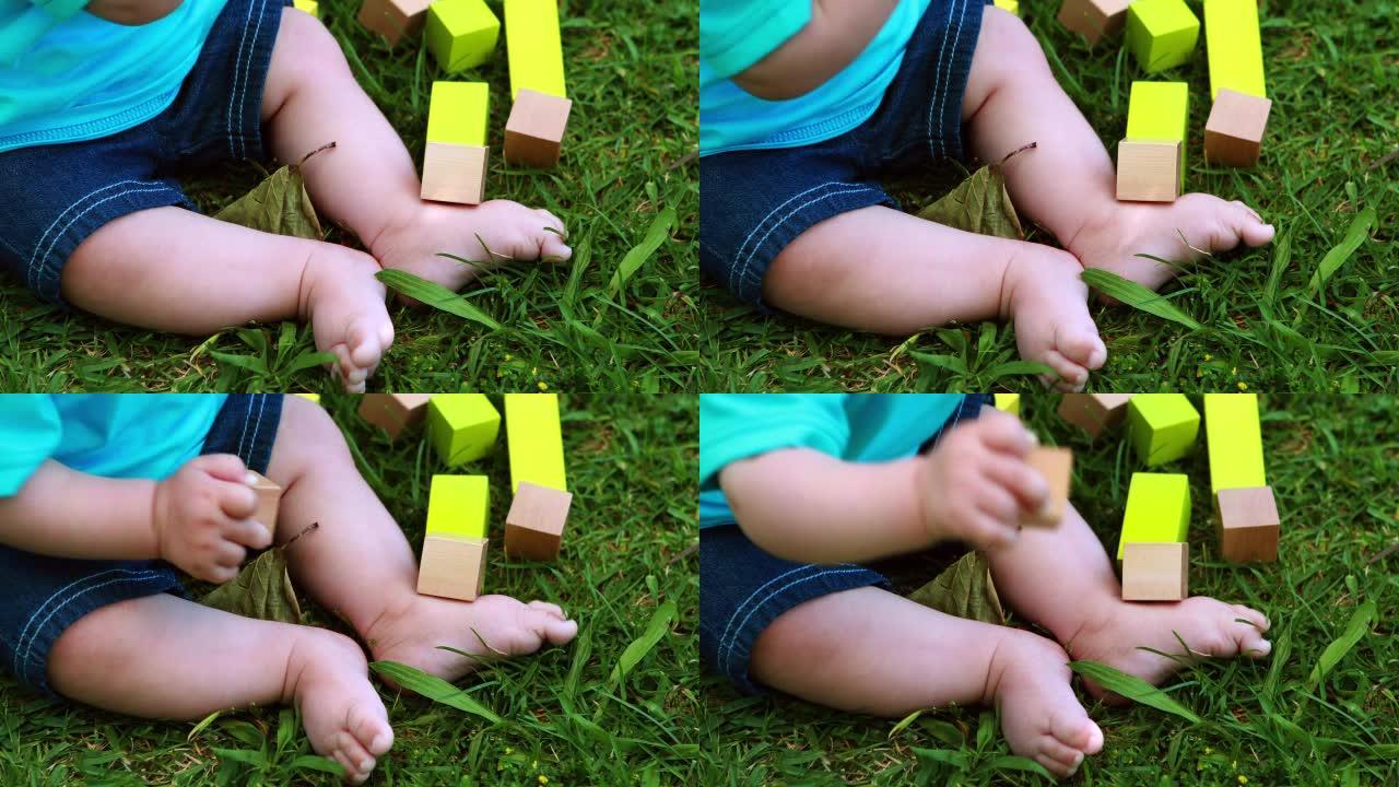 男婴在草地上玩积木