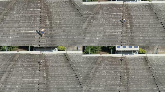 UHD 4k鸟瞰图: 成年男性在体育场楼梯上冲刺