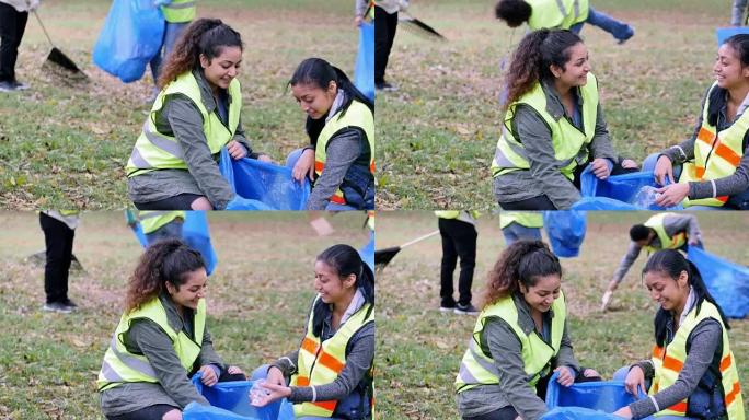 年轻妇女在附近参加社区清洁日
