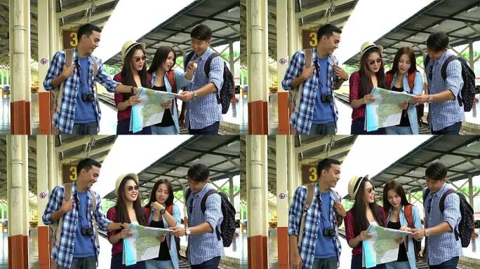 一群年轻的旅行者在火车站寻找地图并讨论他们的旅行。