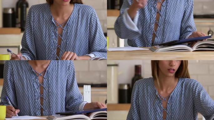 女人在厨房的桌子上研究和做笔记，特写镜头，在R3D上拍摄