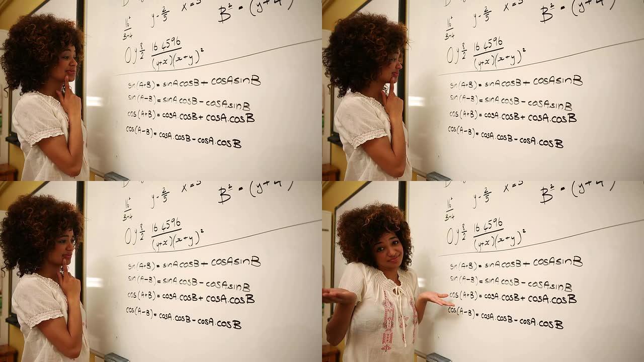 困惑的学生在白板上看数学