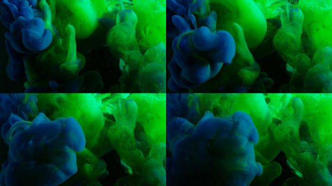 绿色和蓝色霓虹灯涂料混合在黑暗的空间。创造各种艺术造型。