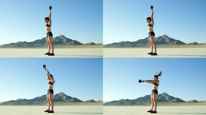 慢动作运动女做水壶铃摇摆沙漠举重锻炼