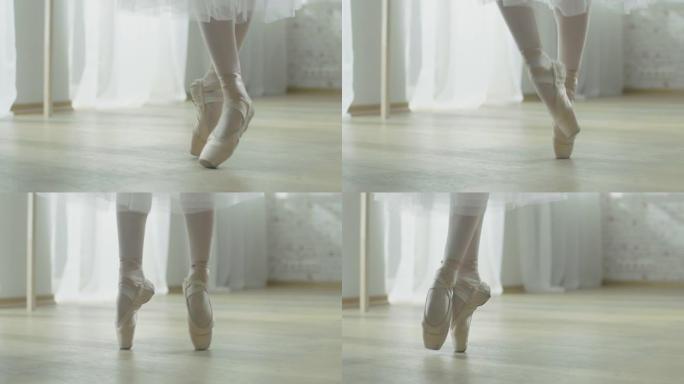 芭蕾舞女演员腿的特写镜头。她穿着尖头芭蕾舞鞋跳舞。她穿着白色短裙。在明亮阳光的现代工作室拍摄。慢动作