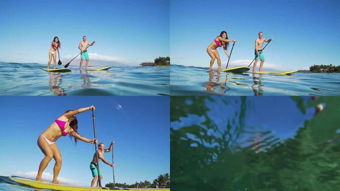 幸福的夫妇站起来划桨冲浪，夏季运动