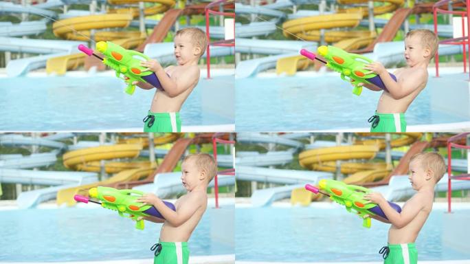 慢动作特写: 快乐的孩子在水上公园用水枪射击和喷水