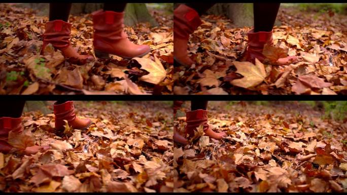 女人在地面上走过秋叶