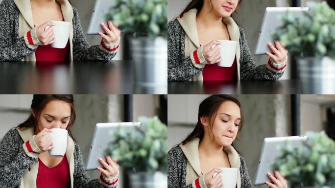 使用数字平板电脑时喝咖啡的女人