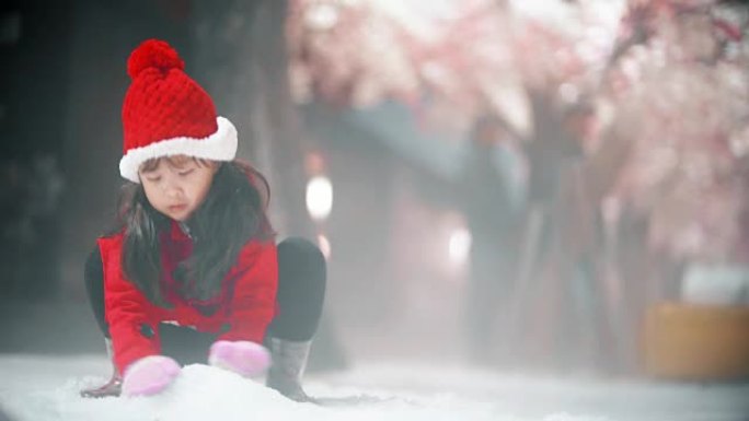 小女孩玩雪樱花树背景