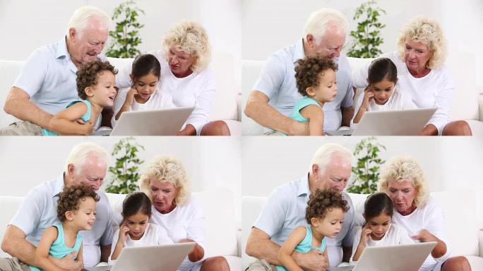 爷爷和奶奶和孙子一起使用平板电脑