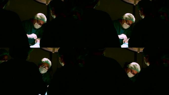 手术室的外科医生团队对病人进行手术。