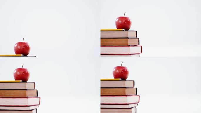 苹果和彩色铅笔在书堆上