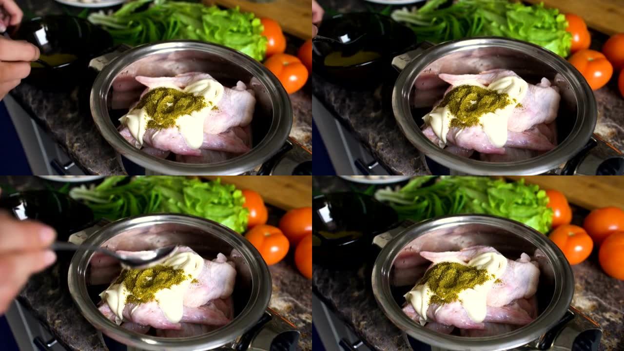 女人做饭的特写镜头将香料放入锅中，在家里的厨房里有chiken的翅膀