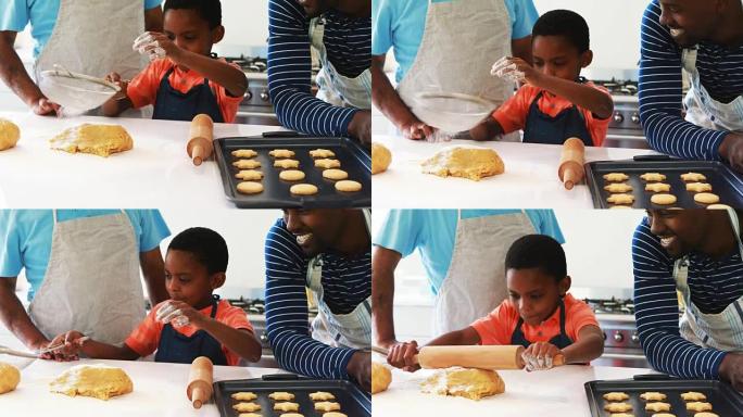 男孩和他的父亲和祖父一起准备饼干