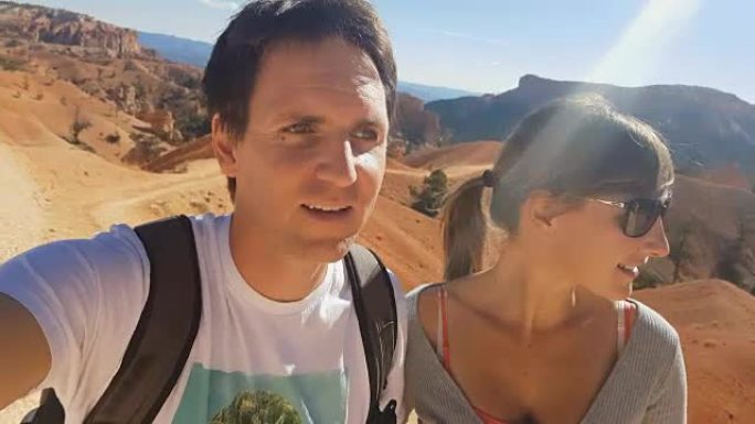 特写: 快乐的年轻旅行者夫妇徒步旅行阳光明媚的布莱斯峡谷小径