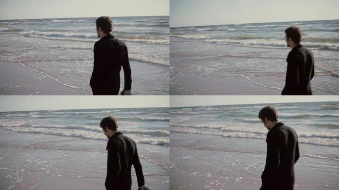 一个年轻人在大风天沿着美丽的海滩散步，手里拿着鞋子