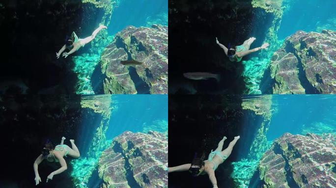 水下: 迷人的年轻女子在Gran Cenote探索洞穴自由潜水
