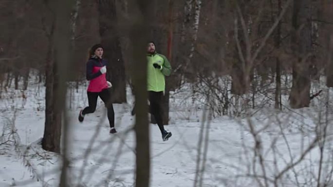 男女练习冬季越野跑步