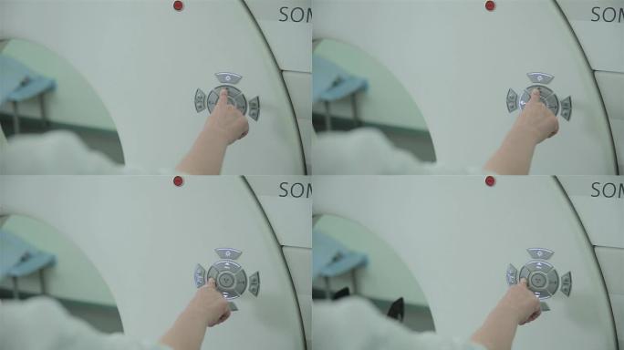 无法识别的医生双手使用计算机断层扫描CT MRI扫描仪进行操作