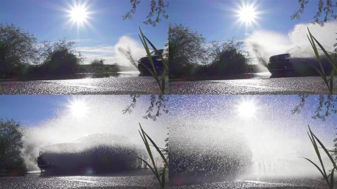 慢动作: SUV汽车在大水坑上潜水，将水溅入相机