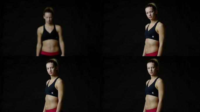 运动金发女子走向相机，聚焦，在R3D上拍摄