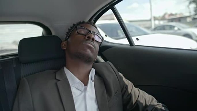非洲商人睡在汽车后座上