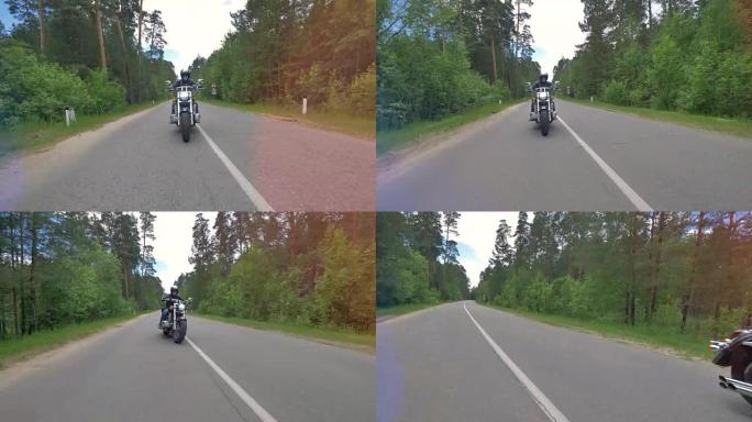 摩托车手改变车道并在乡间小路上骑行。4K。