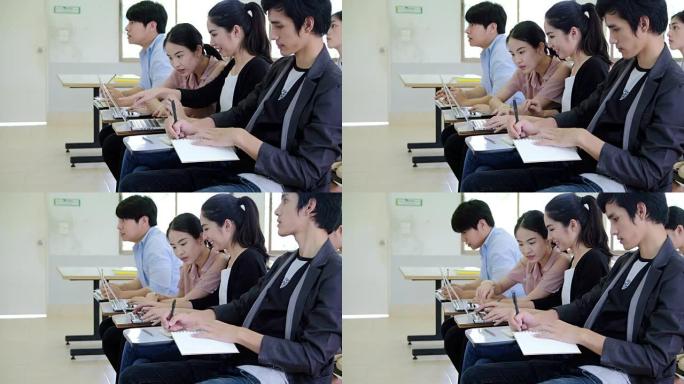 一所大学的一堂课听老师讲，亚洲学生正在学习。