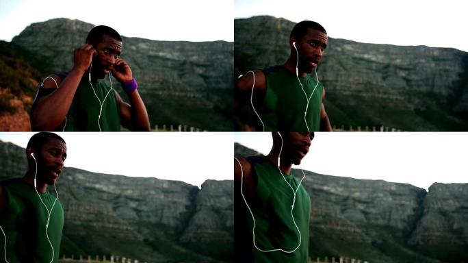 非裔美国人跑步者听着他的耳机寻找灵感